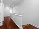 Upstairs hallway with wood floors, white trim, and ample natural light at 202 S Lincoln Ave, Tampa, FL 33609