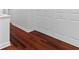 Glossy wood flooring adjacent to white double doors and white baseboards at 202 S Lincoln Ave, Tampa, FL 33609