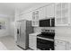 Modern kitchen with stainless steel refrigerator and black range at 202 S Lincoln Ave, Tampa, FL 33609