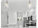Bright kitchen with white cabinets, stainless steel appliances, and pendant lighting at 202 S Lincoln Ave, Tampa, FL 33609