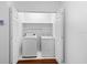 Convenient laundry room with washer, dryer, overhead shelf, and bi-fold closet doors at 202 S Lincoln Ave, Tampa, FL 33609