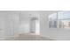 Bright living area featuring tiled floors, plantation shutters, and fresh paint at 202 S Lincoln Ave, Tampa, FL 33609
