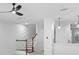 Open-concept living space featuring staircase and modern ceiling fan at 202 S Lincoln Ave, Tampa, FL 33609