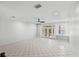 Bright living room featuring tile flooring, ceiling fan, and french doors at 202 S Lincoln Ave, Tampa, FL 33609