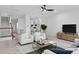 Spacious living room with white chairs, dark floors, and an open floor plan at 202 S Lincoln Ave, Tampa, FL 33609