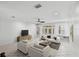 Bright living room featuring tile flooring, ceiling fan, and large windows at 202 S Lincoln Ave, Tampa, FL 33609