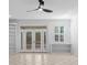 Spacious living room with french doors, built-in bookshelves and natural light at 202 S Lincoln Ave, Tampa, FL 33609