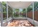 Enclosed patio features tile floor and relaxing views of the backyard greenery at 202 S Lincoln Ave, Tampa, FL 33609
