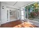 Screened patio with tile floors and lush tropical foliage at 202 S Lincoln Ave, Tampa, FL 33609