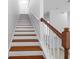 Staircase with white risers, wood treads, and a wood and white banister at 202 S Lincoln Ave, Tampa, FL 33609
