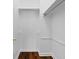 Walk-in closet with hardwood floors, upper shelving, and chrome hanging rods at 202 S Lincoln Ave, Tampa, FL 33609