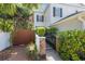 Charming side walkway surrounded by privacy fence and lush landscaping at 202 S Lincoln Ave, Tampa, FL 33609