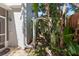 Charming side yard walkway with brick pavers and lush tropical foliage at 202 S Lincoln Ave, Tampa, FL 33609