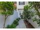 Landscaped walkway with mature trees to the side of the property at 202 S Lincoln Ave, Tampa, FL 33609