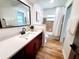 Modern bathroom boasting an updated vanity, stylish mirror, tile accents and wood-look floors at 2172 University S Dr, Clearwater, FL 33764