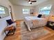 Bright bedroom features a large bed, decorative rug, and a ceiling fan at 2172 University S Dr, Clearwater, FL 33764