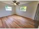 Empty bedroom with wood look floors and great natural light from two windows at 2172 University S Dr, Clearwater, FL 33764