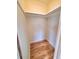 Walk-in closet featuring wood floor, white walls and upper shelving with hanging rod at 2172 University S Dr, Clearwater, FL 33764