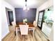 Dining area features wood floors, modern wainscoting, stylish light fixture and view of the back yard at 2172 University S Dr, Clearwater, FL 33764