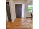 Inviting foyer with wood-look floors, a modern front door, and natural light from the side window at 2172 University S Dr, Clearwater, FL 33764