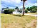 Well-kept single-story home featuring an attached garage, mature trees, and a welcoming front yard at 2172 University S Dr, Clearwater, FL 33764