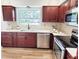 Updated kitchen features stainless steel appliances, plenty of counter space, wood-look floors at 2172 University S Dr, Clearwater, FL 33764