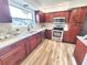 Updated kitchen with stainless steel appliances, solid surface countertops and wood-look flooring at 2172 University S Dr, Clearwater, FL 33764