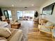 Spacious living room with stylish furniture, hardwood floors, and a view of the screened-in patio at 2172 University S Dr, Clearwater, FL 33764