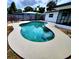 Lovely kidney-shaped pool with spacious deck and lush landscaping at 2172 University S Dr, Clearwater, FL 33764
