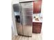 Close-up of stainless steel Samsung refrigerator, matching cabinetry, and solid-surface countertops at 2172 University S Dr, Clearwater, FL 33764