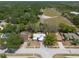 Aerial view of home with spacious backyard in a tranquil neighborhood setting with mature trees at 2336 Windsor Oaks Ave, Lutz, FL 33549