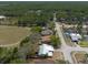 This aerial shows a home in an established neighborhood with tree-lined streets and community amenities nearby at 2336 Windsor Oaks Ave, Lutz, FL 33549