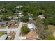 This aerial showcases a home with a metal roof in a well-established neighborhood at 2336 Windsor Oaks Ave, Lutz, FL 33549