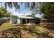 A spacious backyard showcases the home's exterior and a screened patio at 2336 Windsor Oaks Ave, Lutz, FL 33549