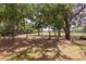 View of the property line with mature trees and a fenced boundary at 2336 Windsor Oaks Ave, Lutz, FL 33549
