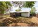 A spacious backyard boasts mature trees, a covered patio, and a fenced boundary at 2336 Windsor Oaks Ave, Lutz, FL 33549