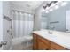 Bathroom features a shower/tub, wood cabinets and vanity at 2336 Windsor Oaks Ave, Lutz, FL 33549