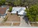 A charming house with a metal roof and front yard, captured from an elevated perspective for a comprehensive view at 2336 Windsor Oaks Ave, Lutz, FL 33549