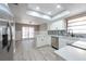 Bright, updated kitchen and dining area with stainless appliances, island, modern backsplash and floors, and skylight at 2336 Windsor Oaks Ave, Lutz, FL 33549
