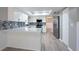 Updated kitchen with white cabinets, breakfast bar, stainless appliances, and tile backsplash at 2336 Windsor Oaks Ave, Lutz, FL 33549