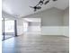Open concept living room with luxury vinyl floors, high ceilings, and lots of natural light at 2336 Windsor Oaks Ave, Lutz, FL 33549