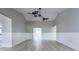 Open-concept living area with high ceilings, ceiling fans and updated vinyl flooring at 2336 Windsor Oaks Ave, Lutz, FL 33549