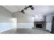 Comfortable living room featuring a stone fireplace and ceiling fans for climate control at 2336 Windsor Oaks Ave, Lutz, FL 33549