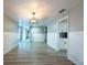 Open living room features updated floors, wainscoting, modern lighting, and connects to other rooms at 2336 Windsor Oaks Ave, Lutz, FL 33549
