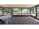 Enclosed porch with paver flooring and views of the back yard at 2336 Windsor Oaks Ave, Lutz, FL 33549