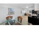 Bright dining area featuring a glass table set and terrazzo floors, transitioning to a kitchen and living room at 2350 38Th N Ave, St Petersburg, FL 33713