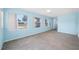Bright living room with light blue walls, tiled floors, and multiple windows for natural light, creating a calming space at 2350 38Th N Ave, St Petersburg, FL 33713