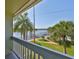 Balcony view of the community waterfront, docks, and palm trees at 2424 W Tampa Bay Blvd # I202, Tampa, FL 33607
