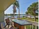 Enjoy waterfront views from this balcony with seating, overlooking the pool and manicured grounds at 2424 W Tampa Bay Blvd # I202, Tampa, FL 33607