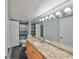 Bathroom with a granite countertop, large mirror, and tiled floor at 2424 W Tampa Bay Blvd # I202, Tampa, FL 33607
